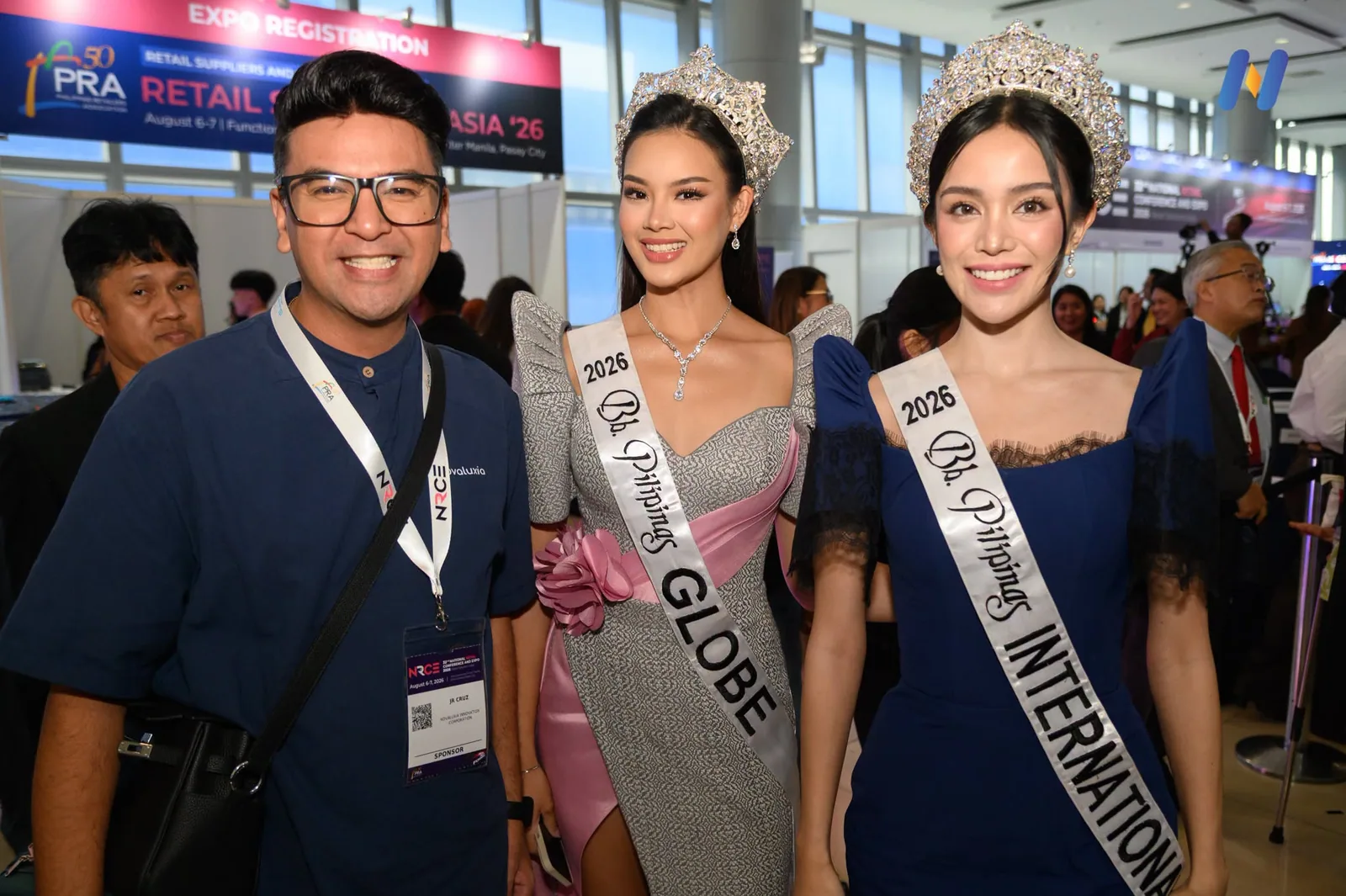 Novaluxia PH staff photographed with the two Bb. Pilipinas 2026 titleholders at the retail expo booth